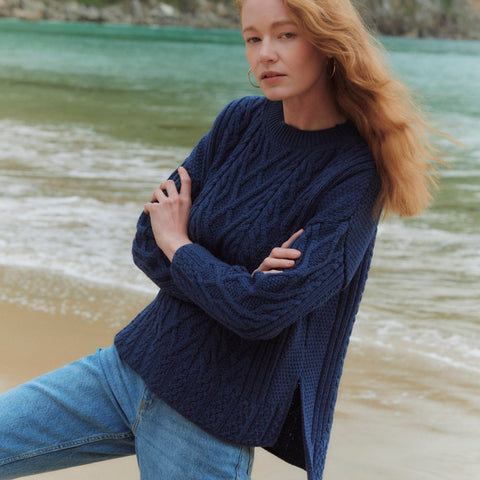 Woman wearing a Navy Aran Sweater with side slit
