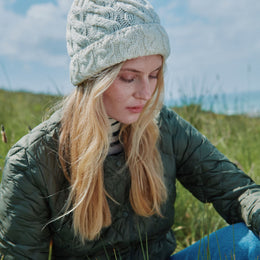 Clifden Cable Aran-Mütze mit Bommeln - Creme